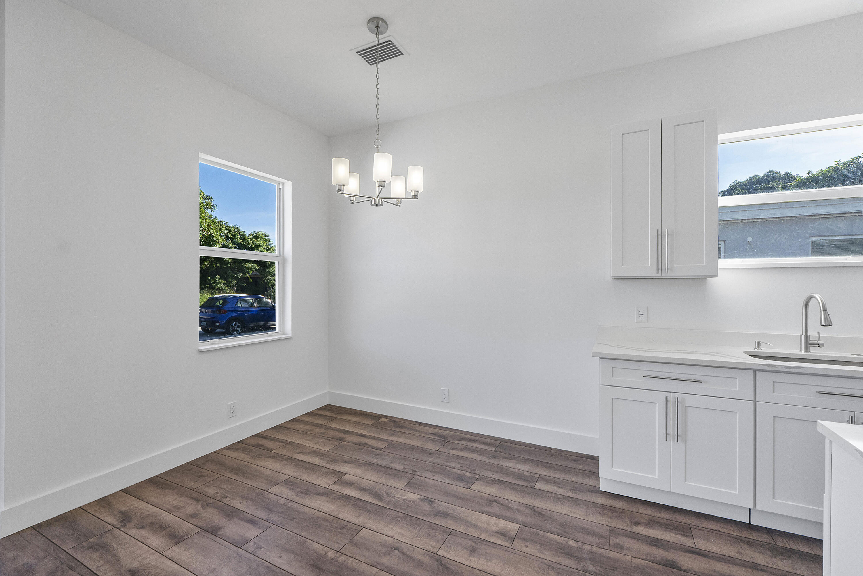 1573 West 16th Street Riviera Beach, FL 33404 - Photo 9 of 23 a view of a kitchen sink and dishwasher with wooden floor