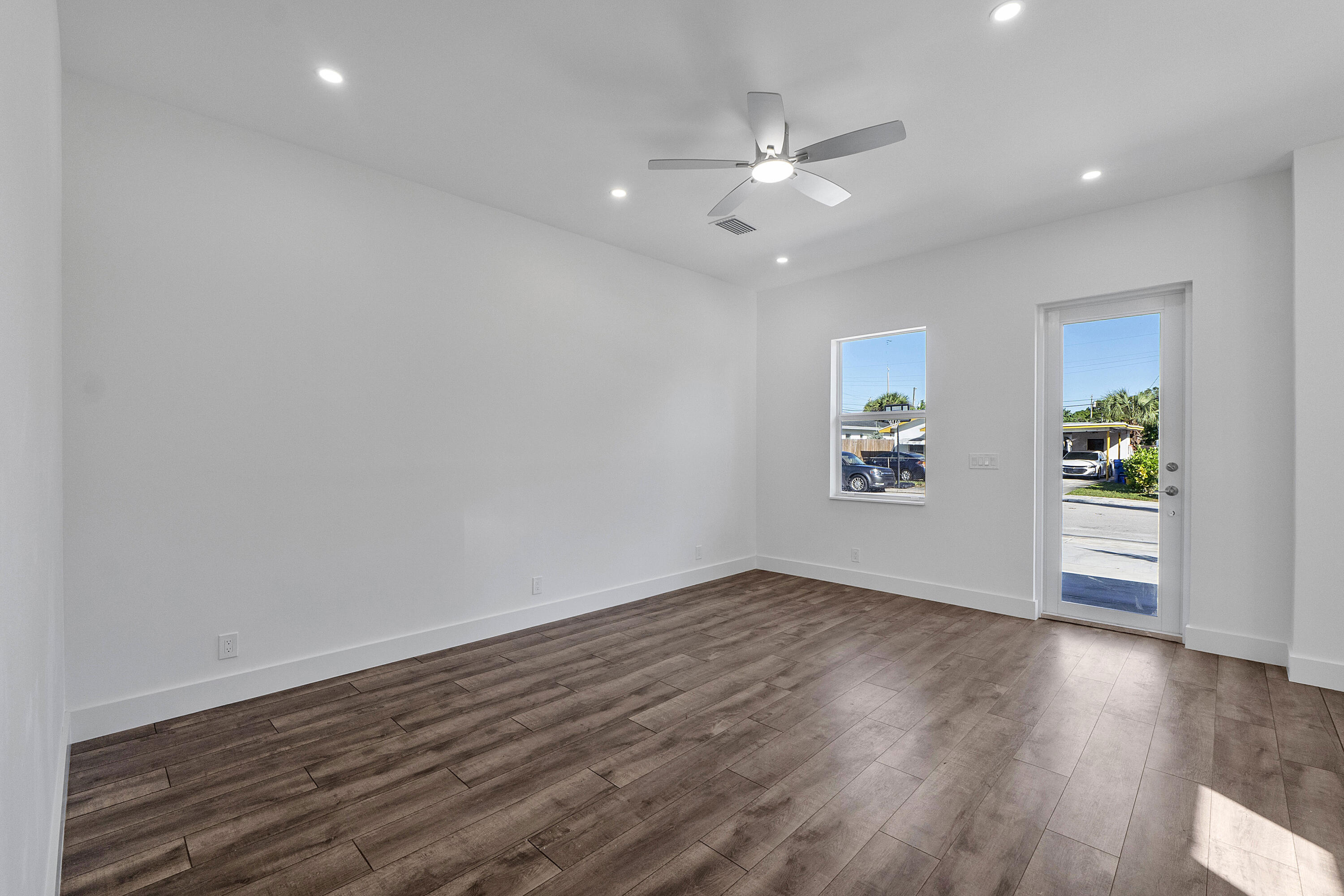 1573 West 16th Street Riviera Beach, FL 33404 - Photo 10 of 23 wooden floor in an empty room with a window