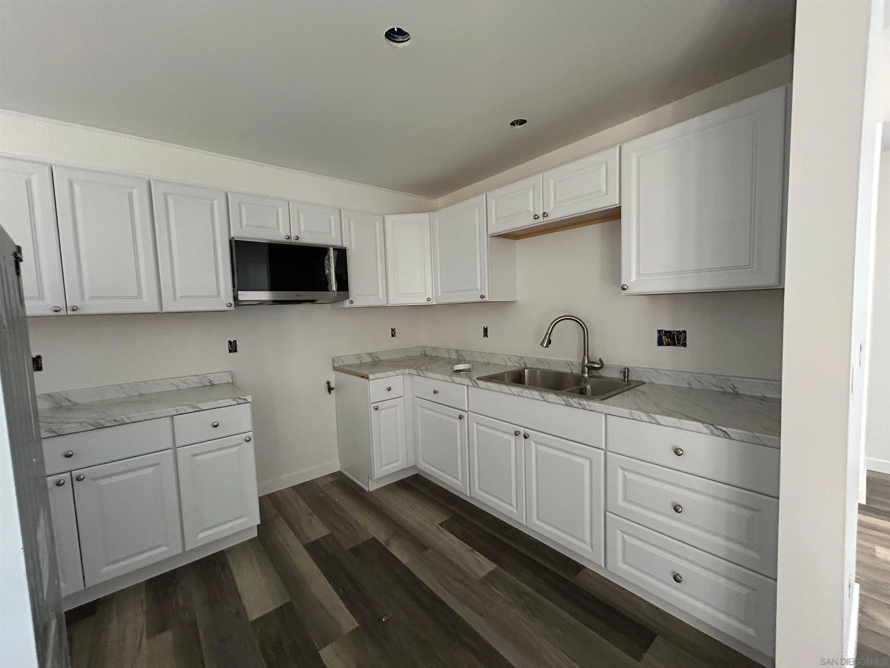 565 North Beech Street Escondido, CA 92025 - Photo 11 of 24 a kitchen with sink stove and cabinets