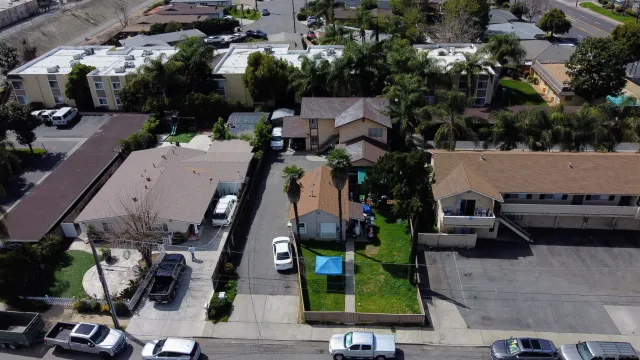 an aerial view of multiple houses with a yard