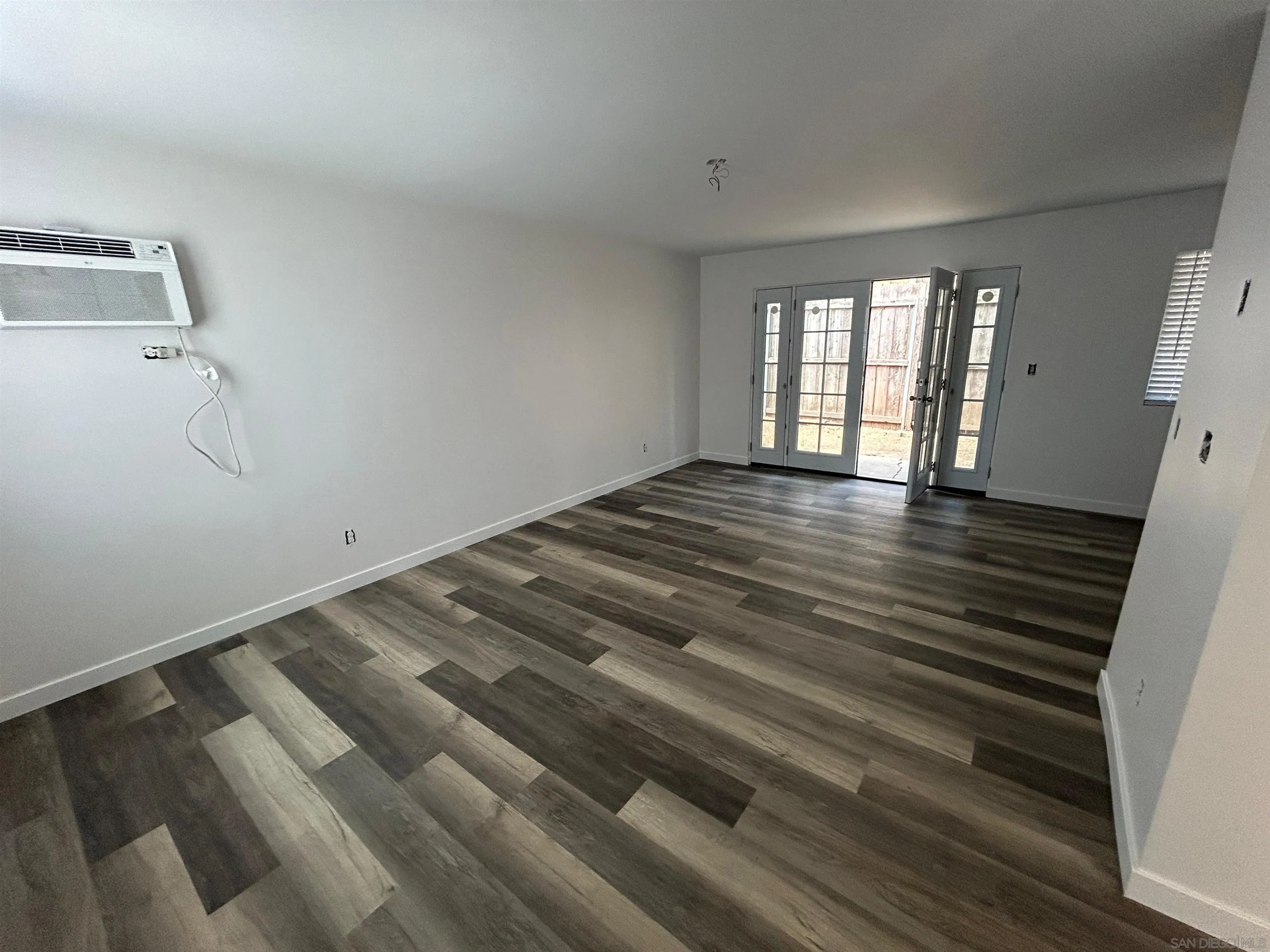 565 North Beech Street Escondido, CA 92025 - Photo 8 of 24 a view of an empty room with wooden floor and a window
