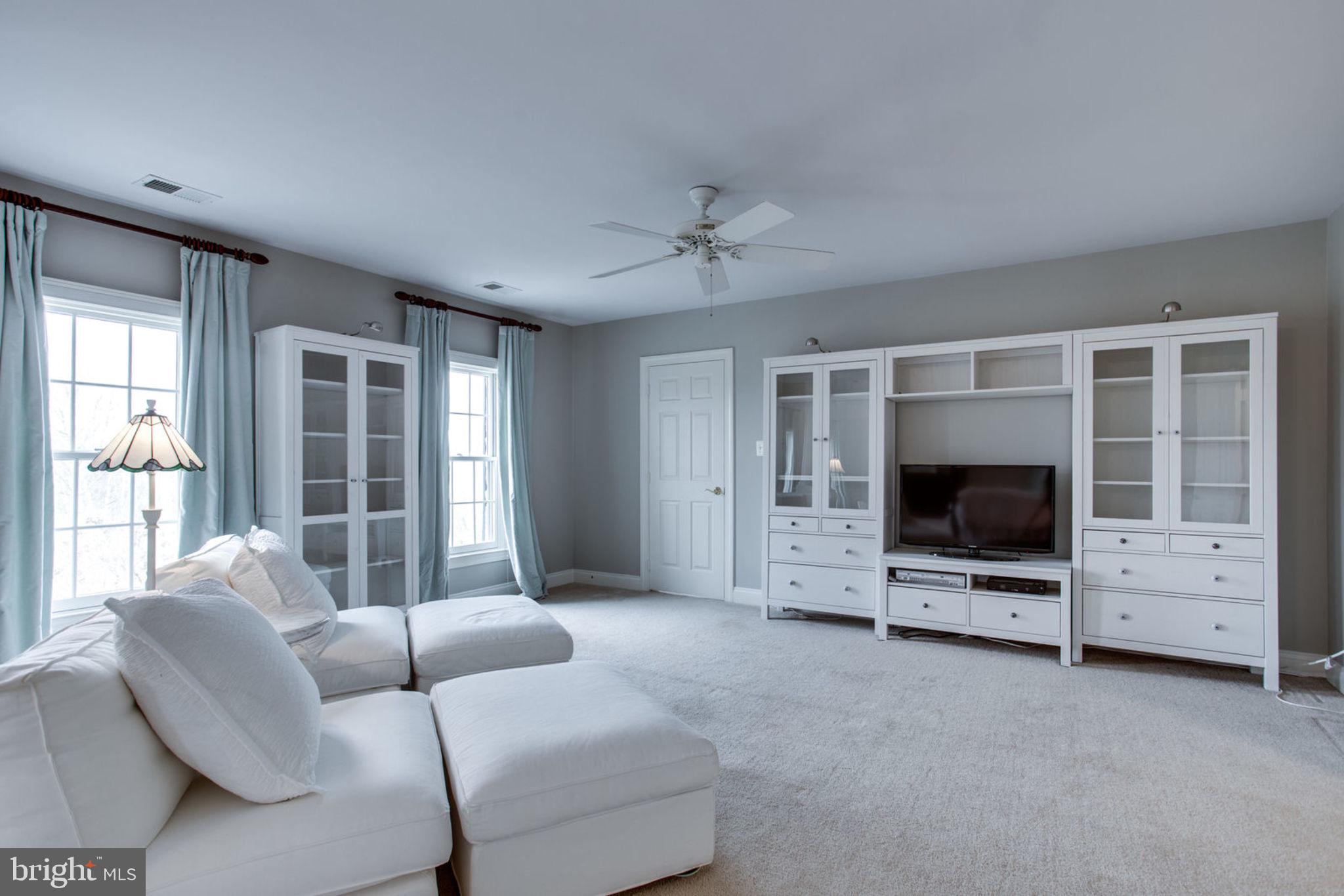 18621 Thundercloud Road Boyds, MD 20841 - Photo 39 of 83 a living room with furniture and a flat screen tv