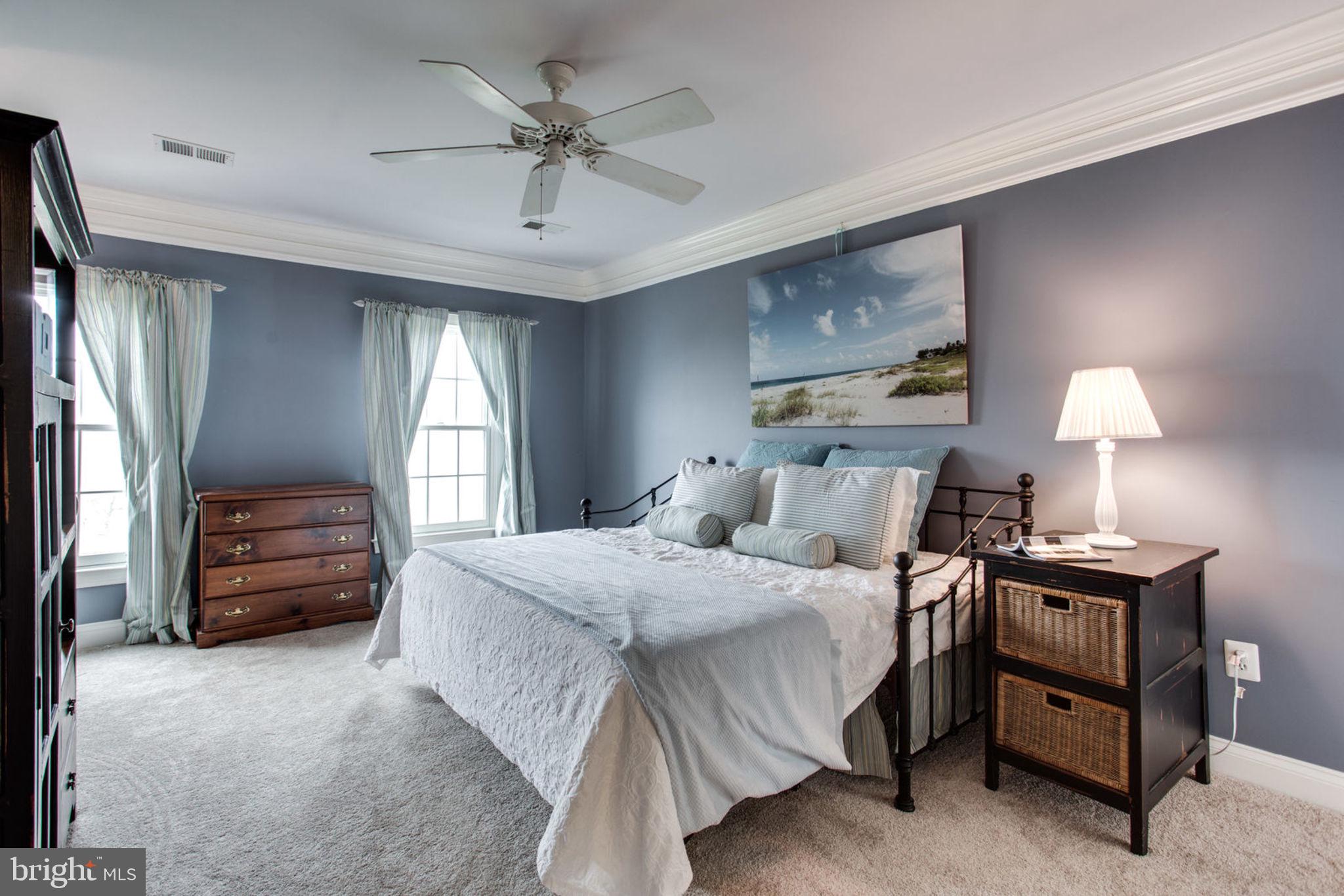 18621 Thundercloud Road Boyds, MD 20841 - Photo 53 of 83 a bedroom with a bed a chandelier and dresser