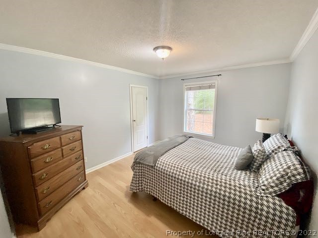670 Shady Grove Road Carthage, NC 28327 - Photo 23 of 34 a bedroom with a bed and a flat screen tv