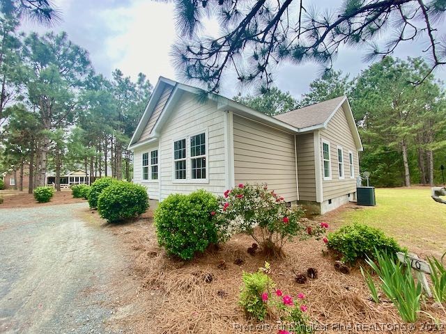 670 Shady Grove Road Carthage, NC 28327 - Photo 3 of 34 a front view of a house with garden