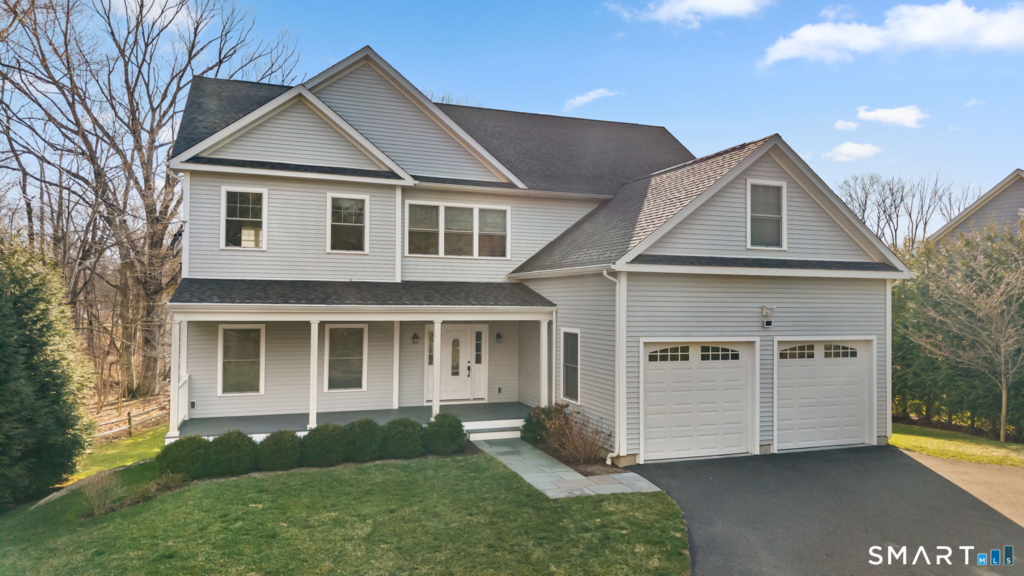 1049 Stillwater Road Stamford, CT 06902 - Photo 4 of 34 a front view of a house with a yard