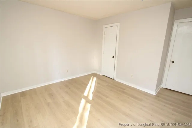 a view of a room with wooden floor