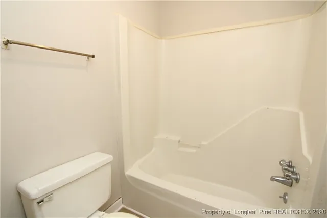 a bathroom with a toilet and a bathtub