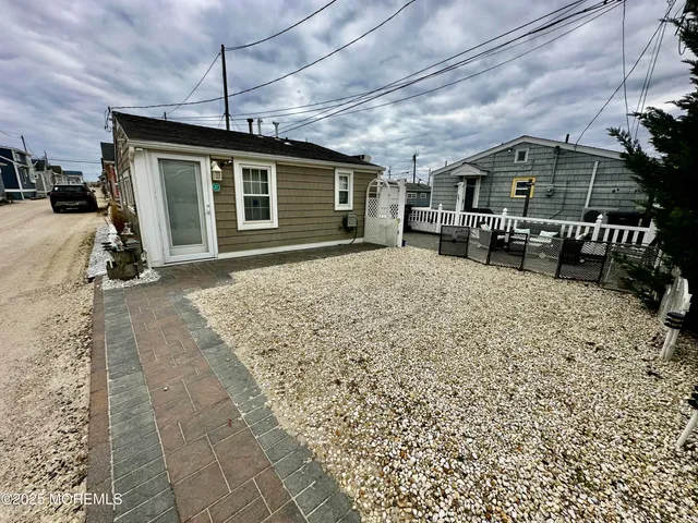 a front view of a house with a yard outdoor seating and garage