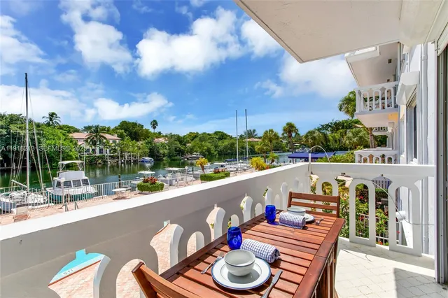 a view of a balcony dining table and chairs with wooden floor