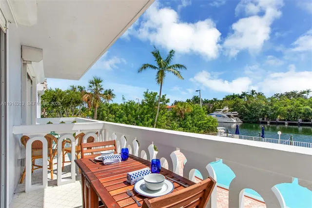 a balcony with table and chairs