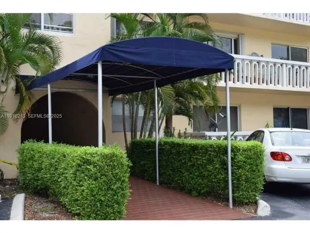 a front view of a house with yard and green space