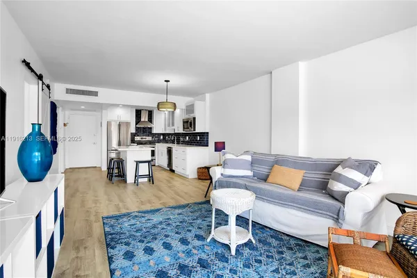 a living room with furniture a rug and a coffee table