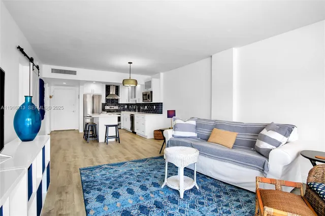 a living room with furniture a rug and a coffee table