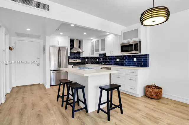 a kitchen with stainless steel appliances a microwave a stove a microwave a sink a stove and cabinets