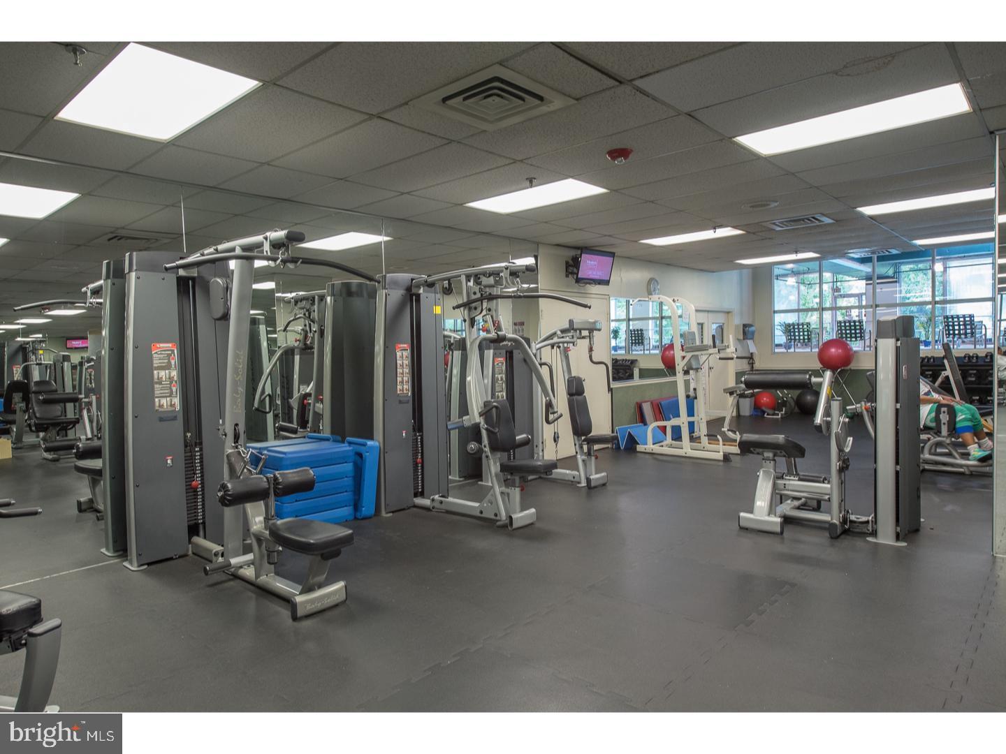 3900-00 West Ford Road, Unit 14K Philadelphia, PA 19131 - Photo 39 of 42 Modern fitness center with ample equipment.