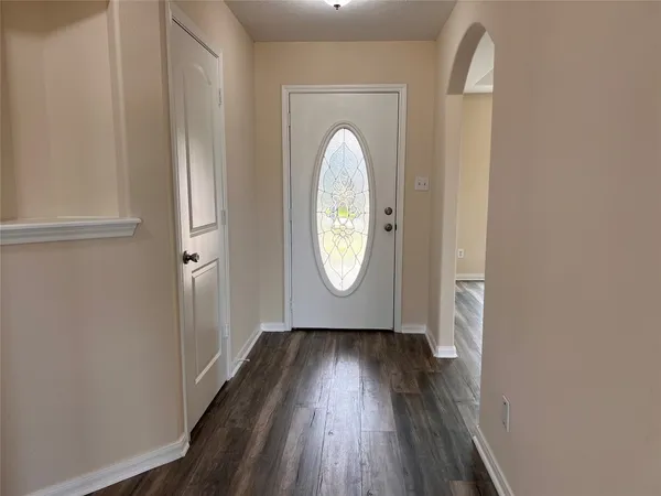 a view of a livingroom with wooden floor and window