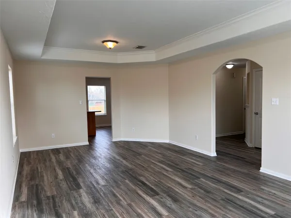 an empty room with wooden floor and closet