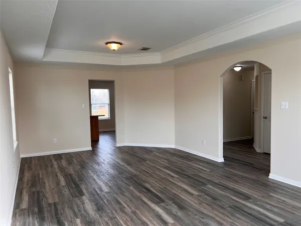 an empty room with wooden floor and closet