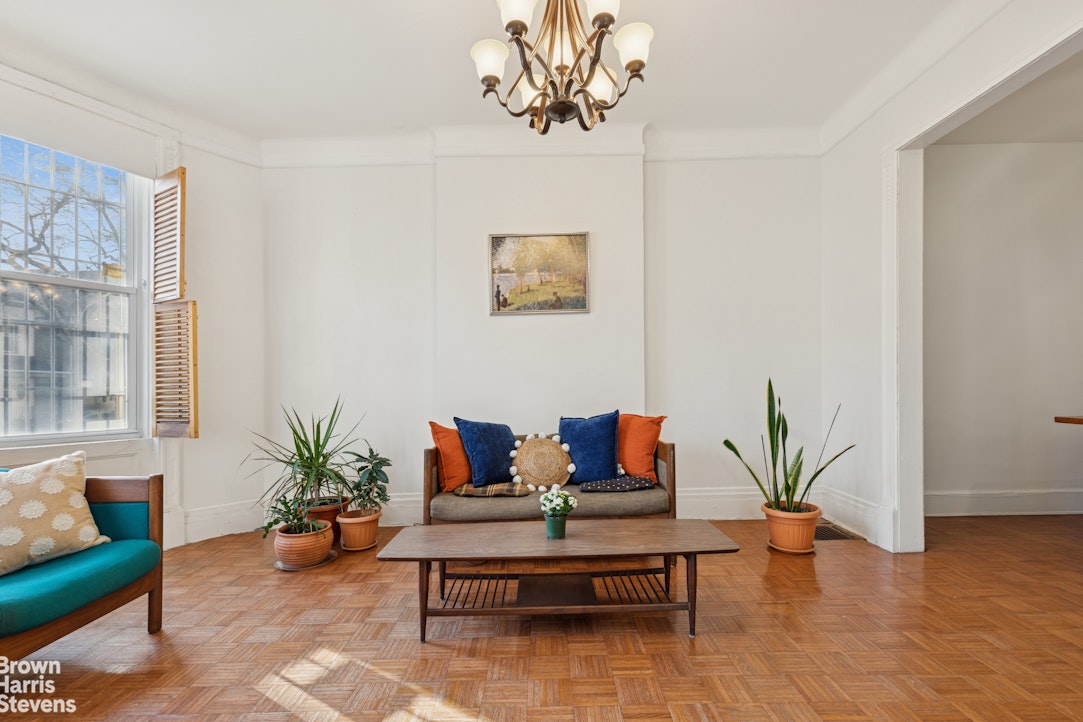 251 Rutland Road Brooklyn, NY 11225 - Photo 10 of 16 a living room with furniture and wooden floor