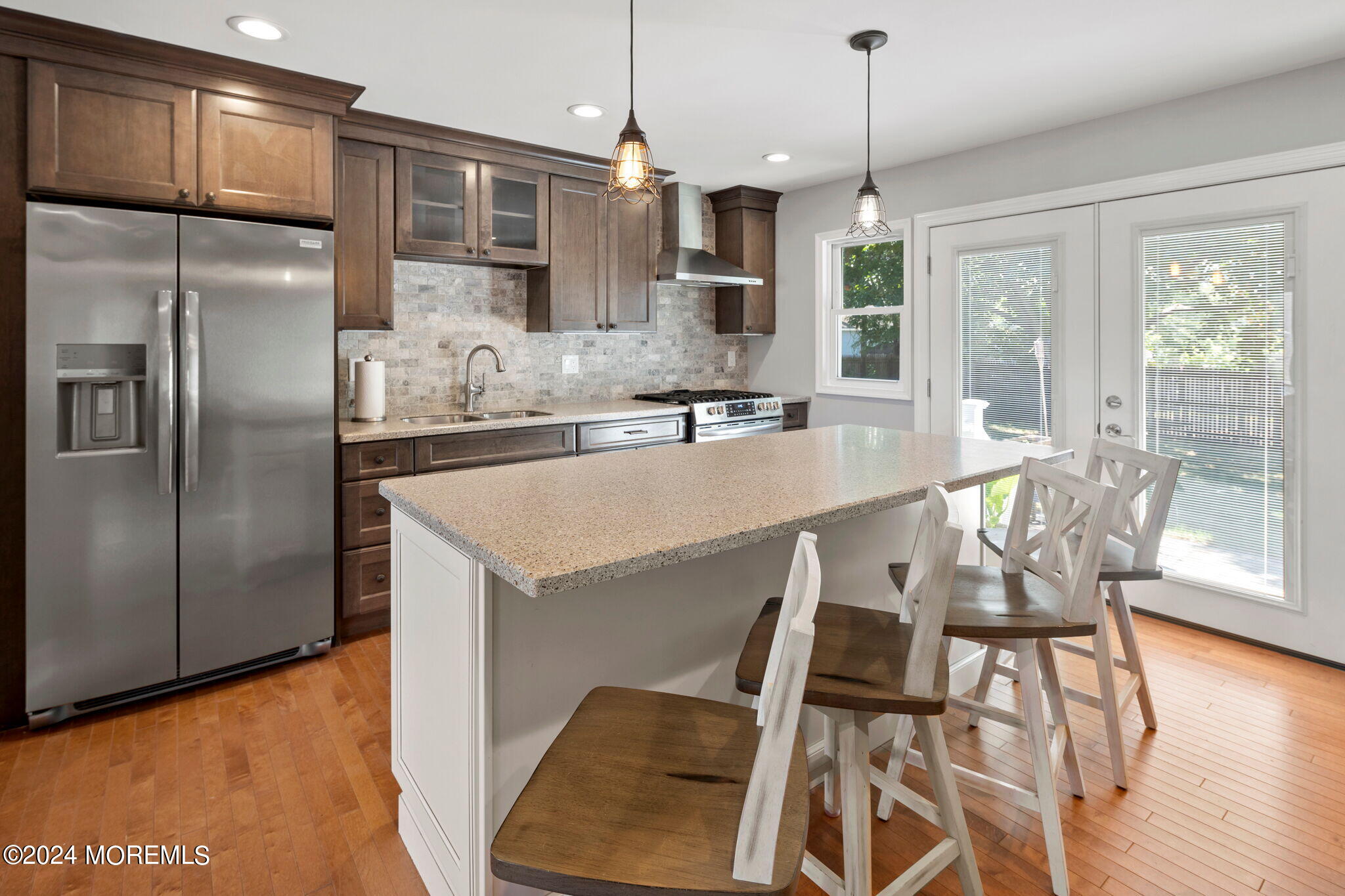 740 Midstreams Road Brick, NJ 08724 - Photo 11 of 31 a kitchen with stainless steel appliances granite countertop a refrigerator a stove a sink dishwasher with a dining table and chairs