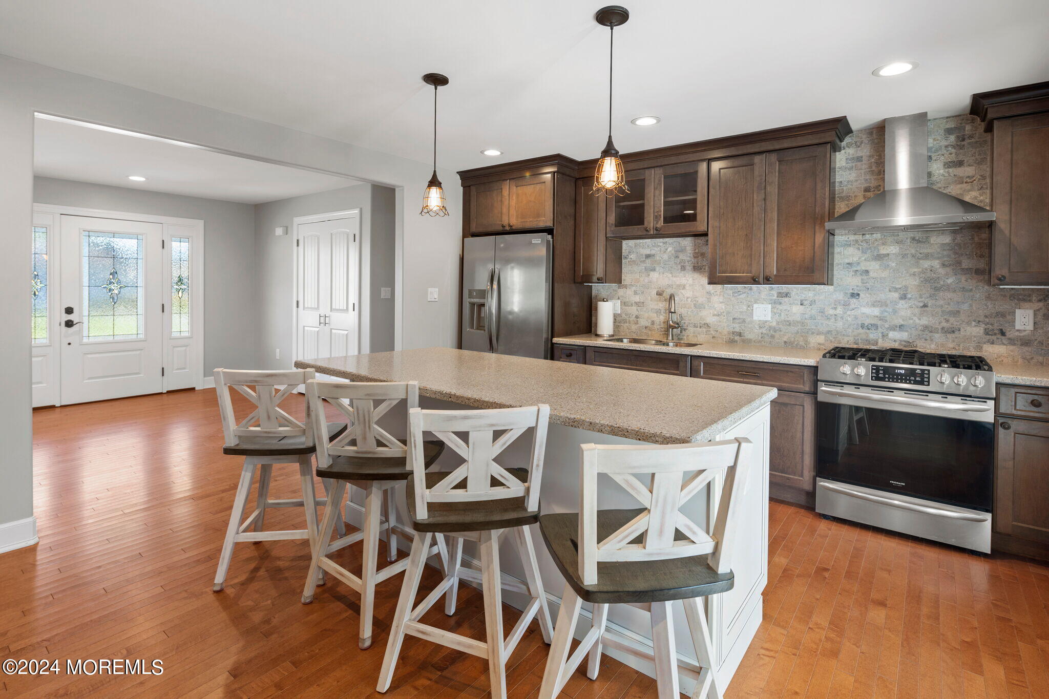 740 Midstreams Road Brick, NJ 08724 - Photo 14 of 31 a kitchen with a table chairs stainless steel appliances and wooden floor