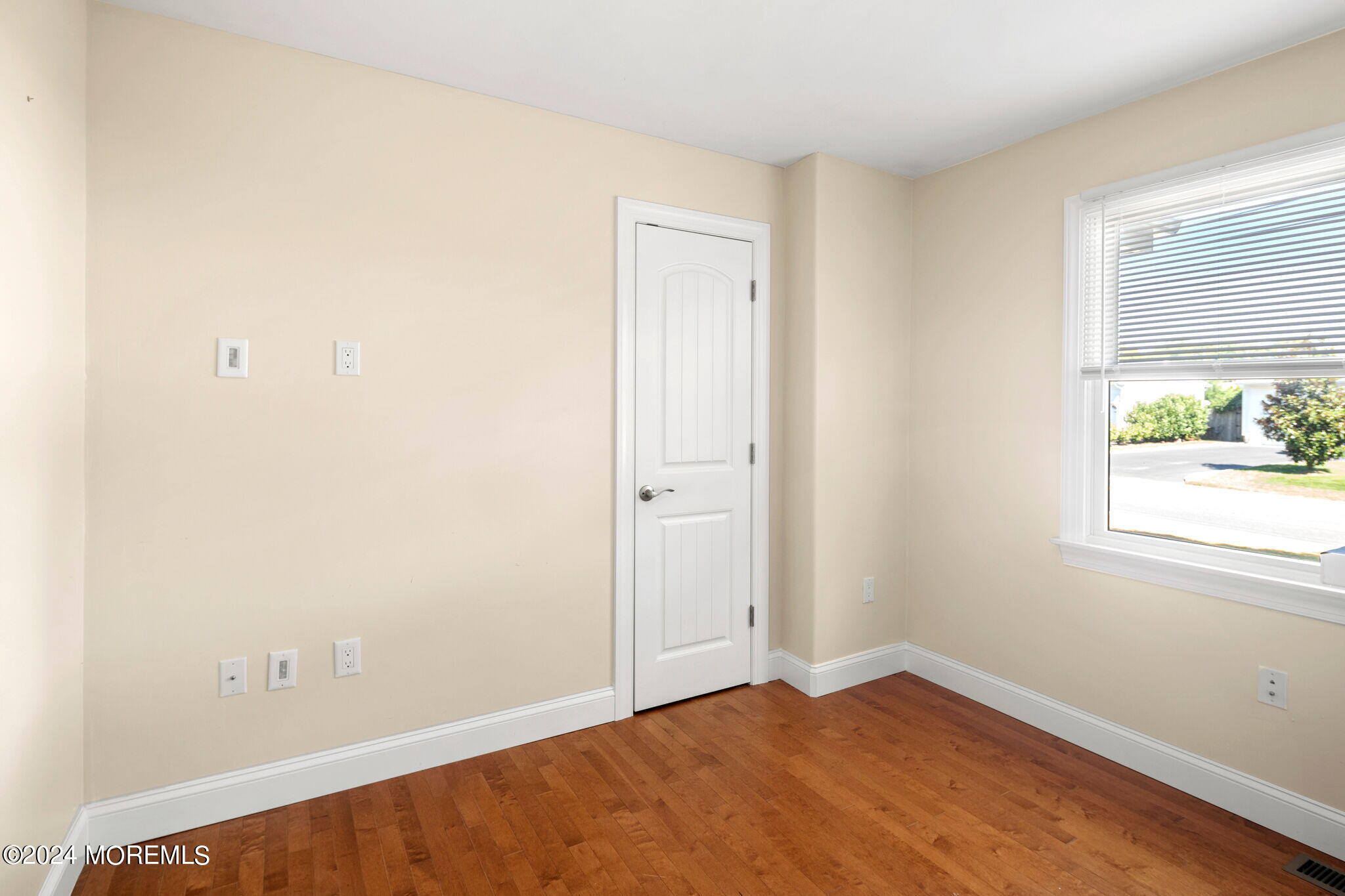 740 Midstreams Road Brick, NJ 08724 - Photo 16 of 31 a view of an empty room with wooden floor and a window