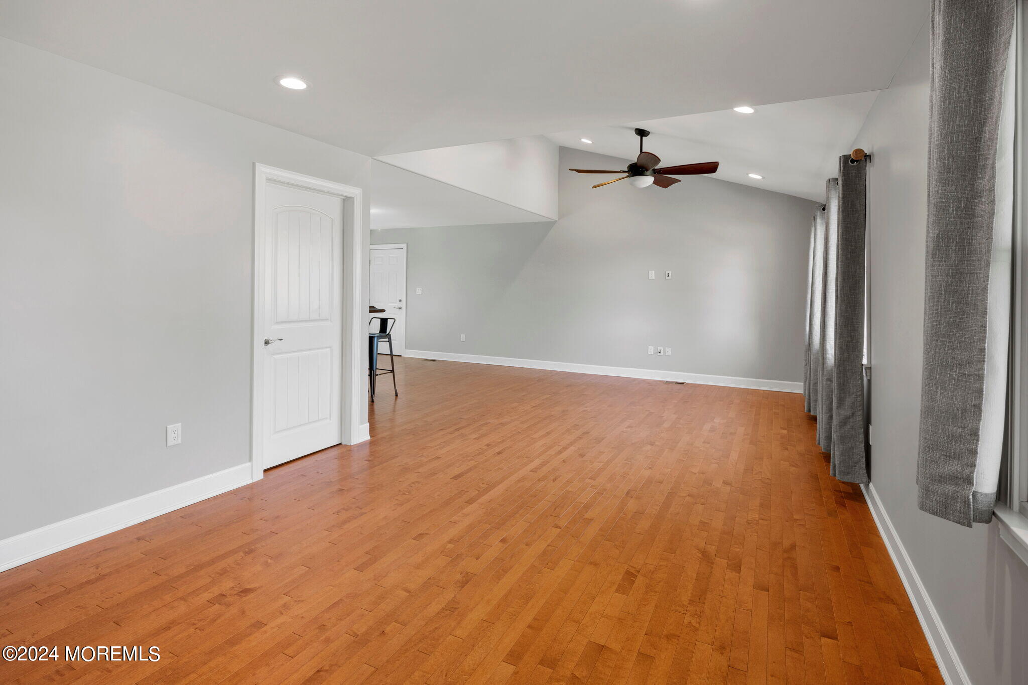 740 Midstreams Road Brick, NJ 08724 - Photo 5 of 31 an empty room with wooden floor ceiling fan and windows
