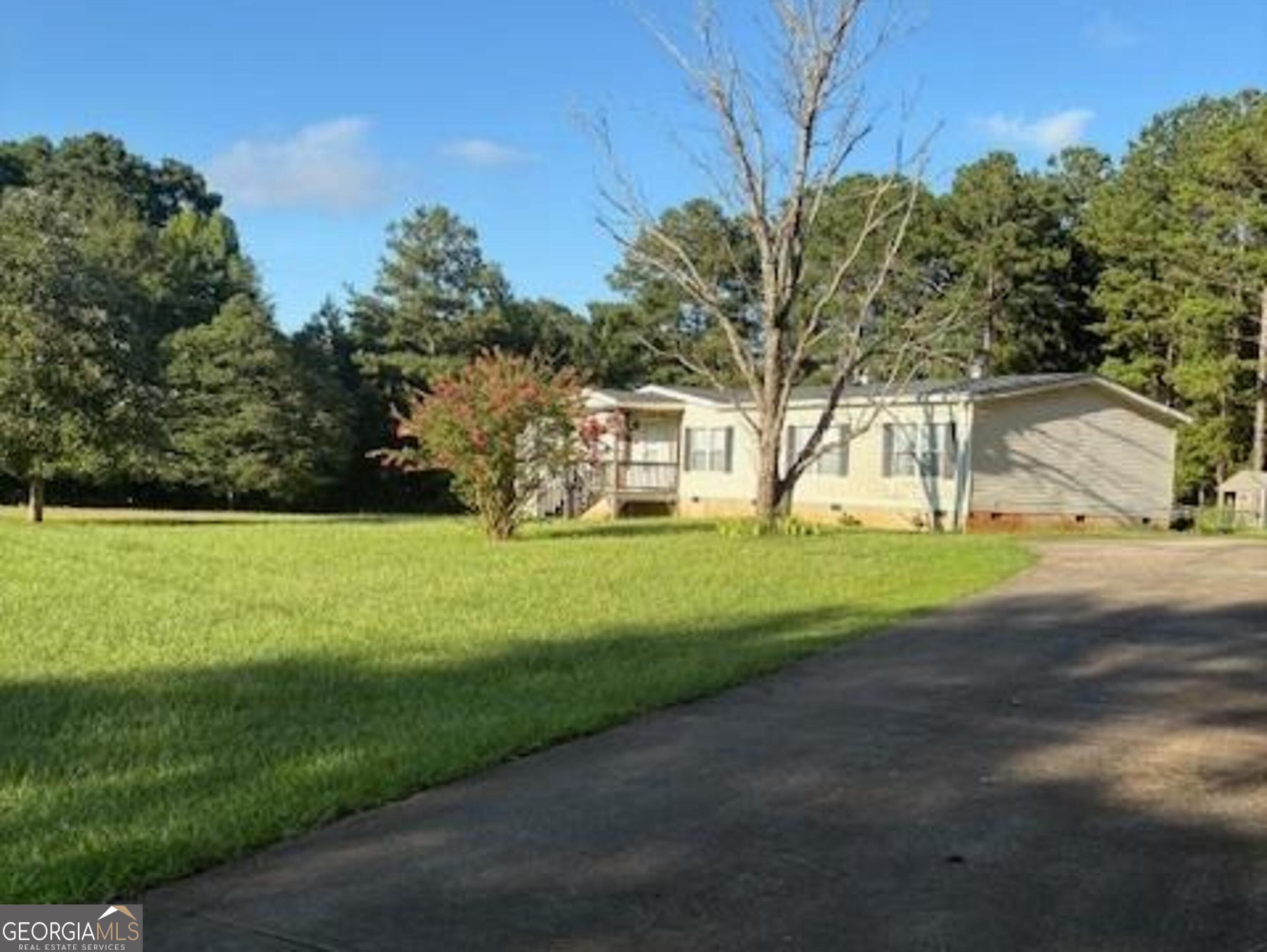 171 Ridgeway Road Milner, GA 30257 - Photo 1 of 1 a view of a house with a big yard