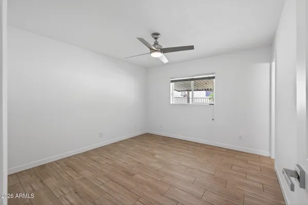 a large kitchen with stainless steel appliances kitchen island granite countertop a refrigerator and a sink