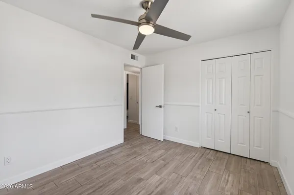 a view of a room with wooden floor