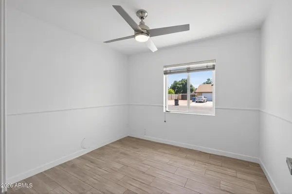 a view of empty room with wooden floor