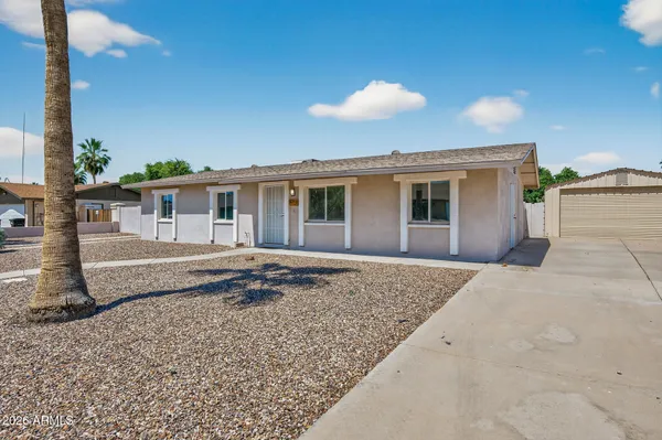 a view of house with yard and entertaining space
