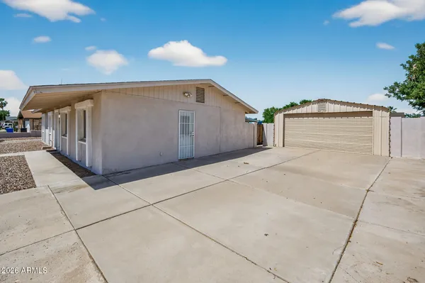 a view of a house with a patio and couches chairs
