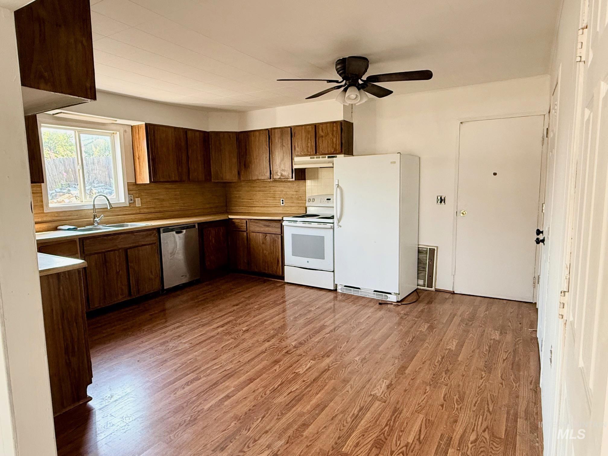 126 Aitken Road Weippe, ID 83553 - Photo 8 of 39 Kitchen featuring wood-finish flooring and ample cabinetry