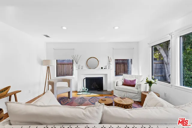 a living room with furniture fireplace and a flat screen tv