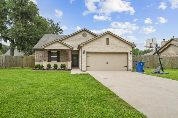 a front view of a house with a yard and garage