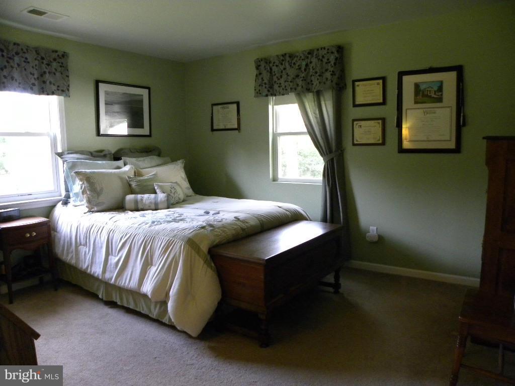 2414 Busic Church Road Marydel, MD 21649 - Photo 20 of 30 a bedroom with a bed lamp and a window