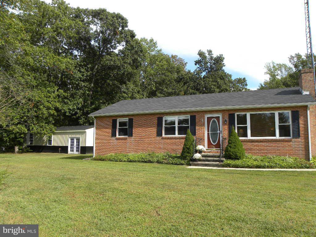 2414 Busic Church Road Marydel, MD 21649 - Photo 30 of 30 a front view of house with yard and trees in the background
