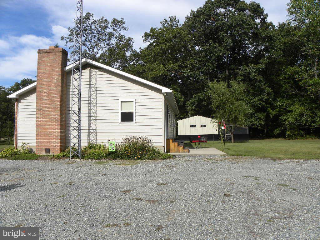 2414 Busic Church Road Marydel, MD 21649 - Photo 5 of 30 a house with a yard and garage