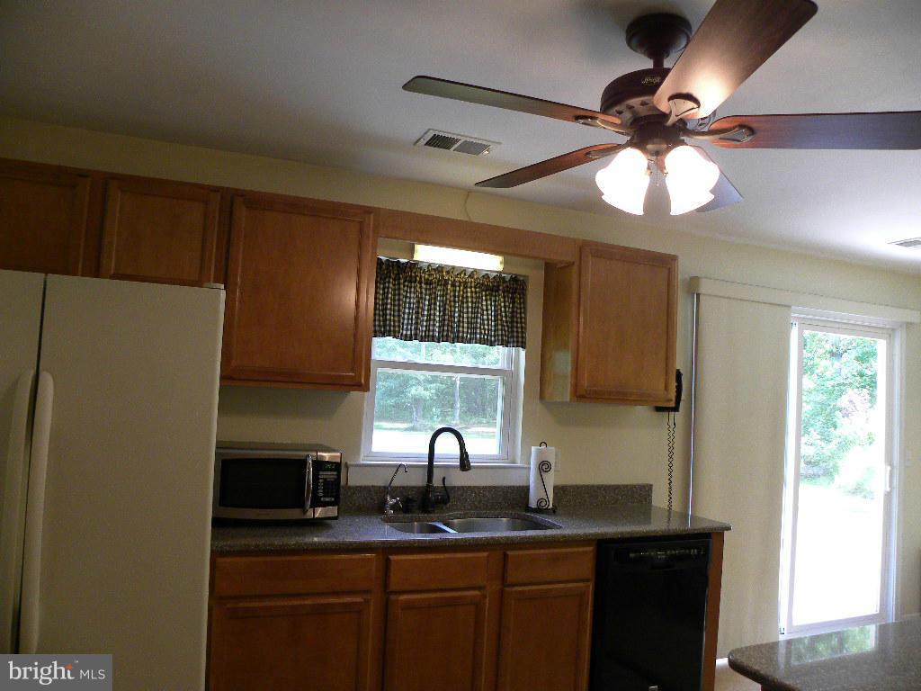 2414 Busic Church Road Marydel, MD 21649 - Photo 10 of 30 a kitchen with a sink stainless steel appliances and a window