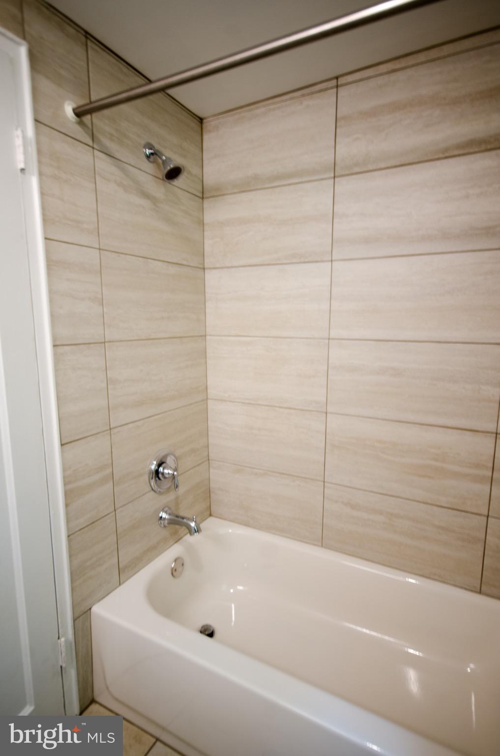 8201 Grubb Road, Unit 101 Silver Spring, MD 20910 - Photo 15 of 31 a bathroom with a bathtub and a shower