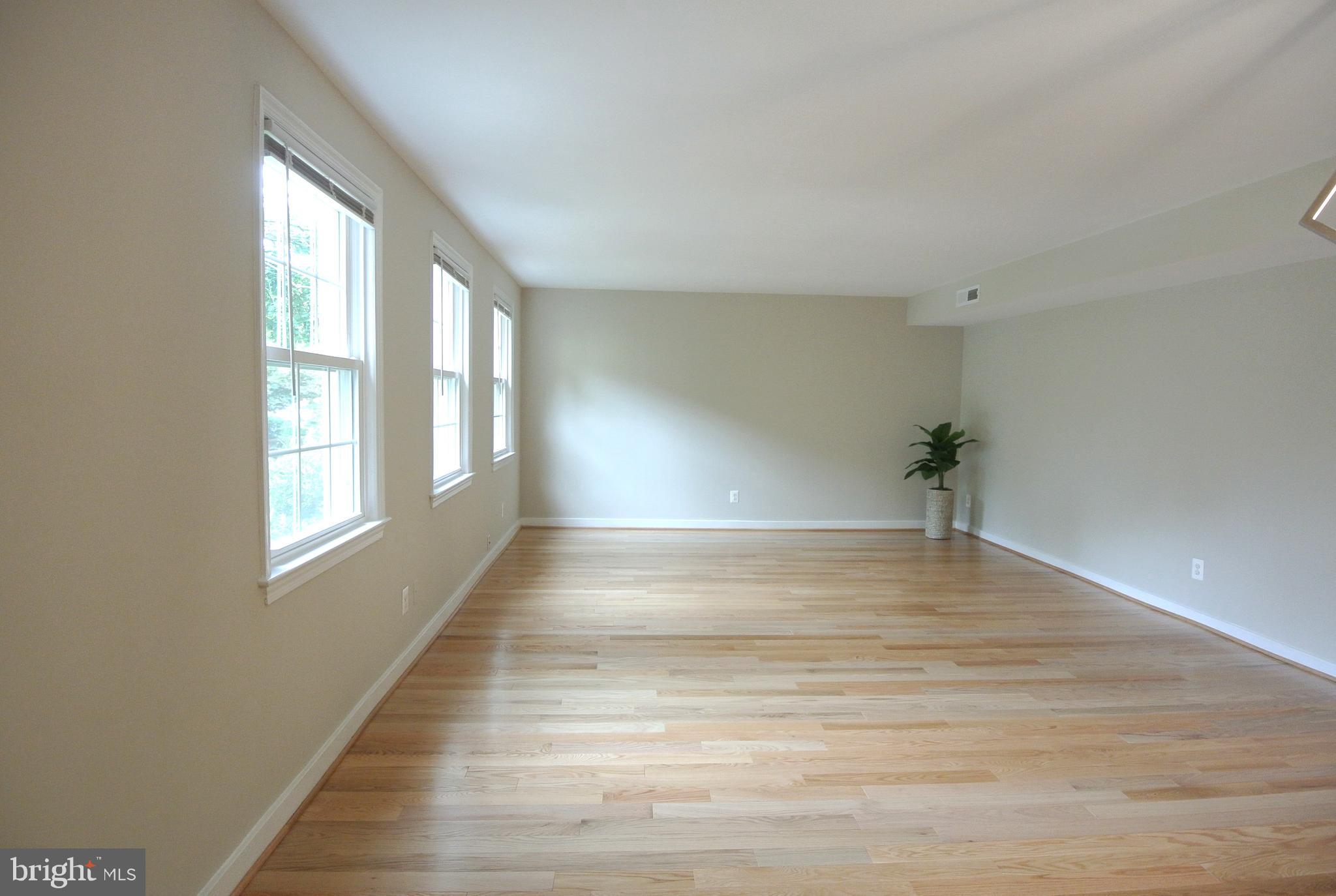 8201 Grubb Road, Unit 101 Silver Spring, MD 20910 - Photo 4 of 31 a view of empty room with wooden floor and fan