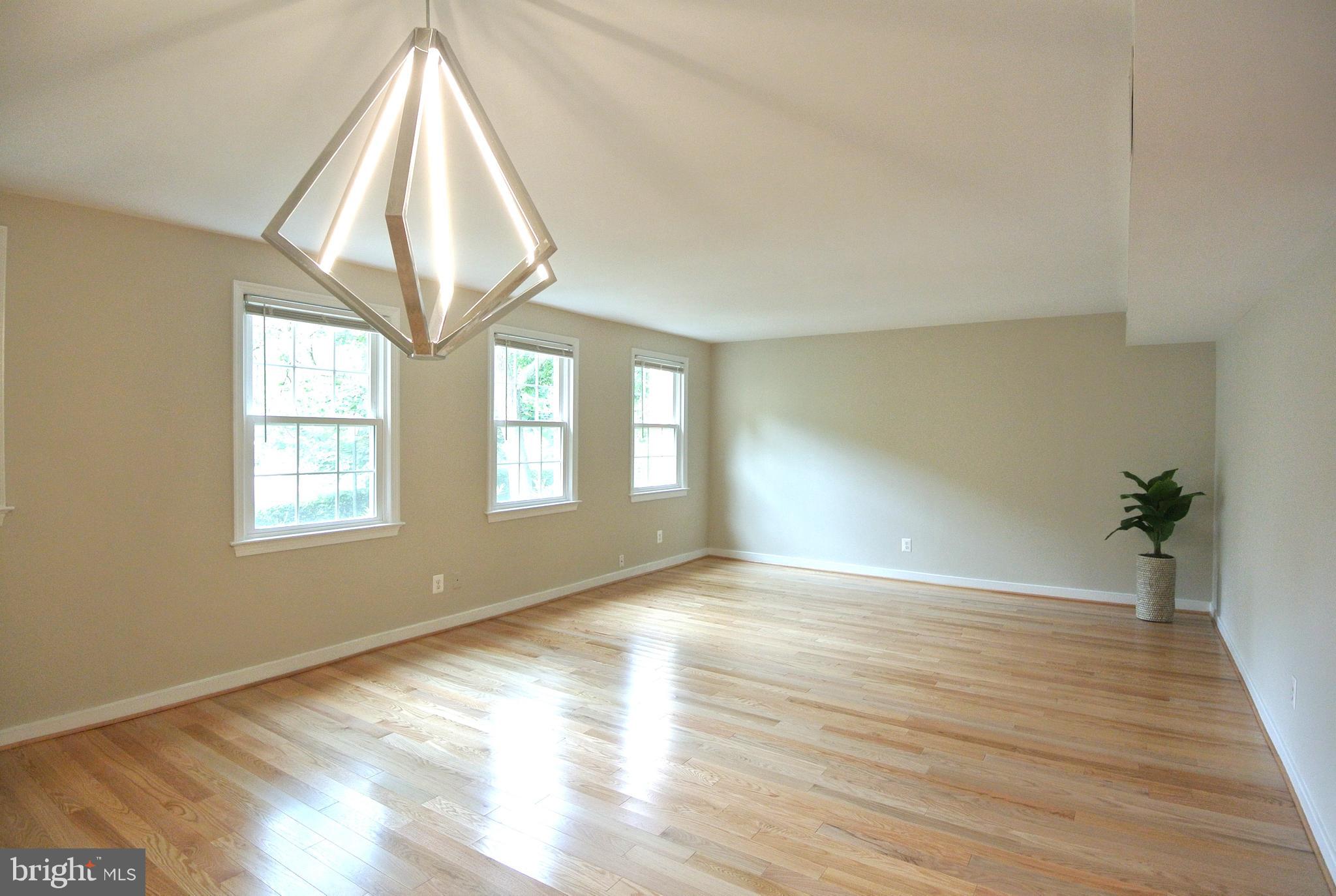 8201 Grubb Road, Unit 101 Silver Spring, MD 20910 - Photo 5 of 31 wooden floor in an empty room with a window