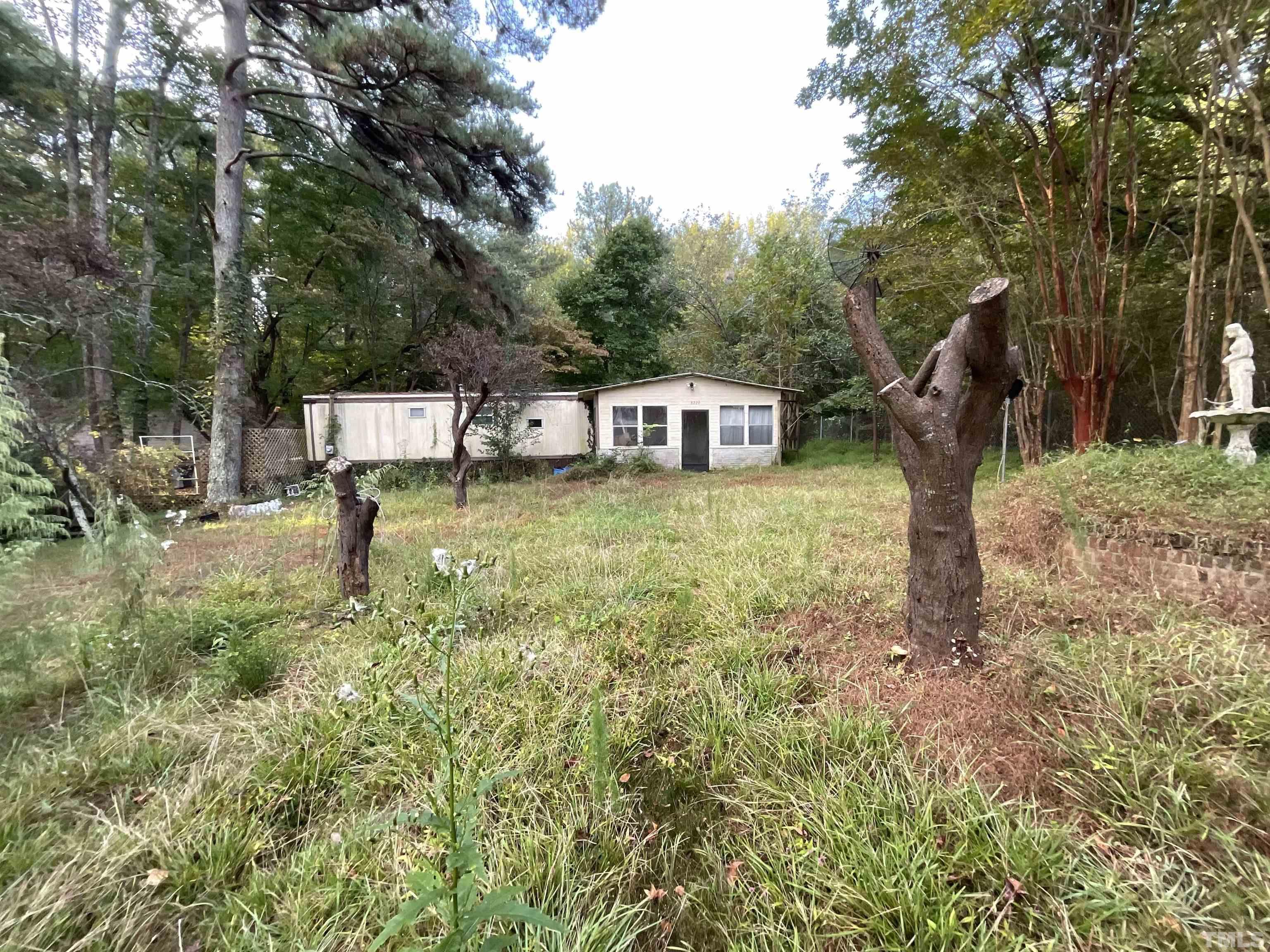 a view of a house with a yard balcony and sitting area