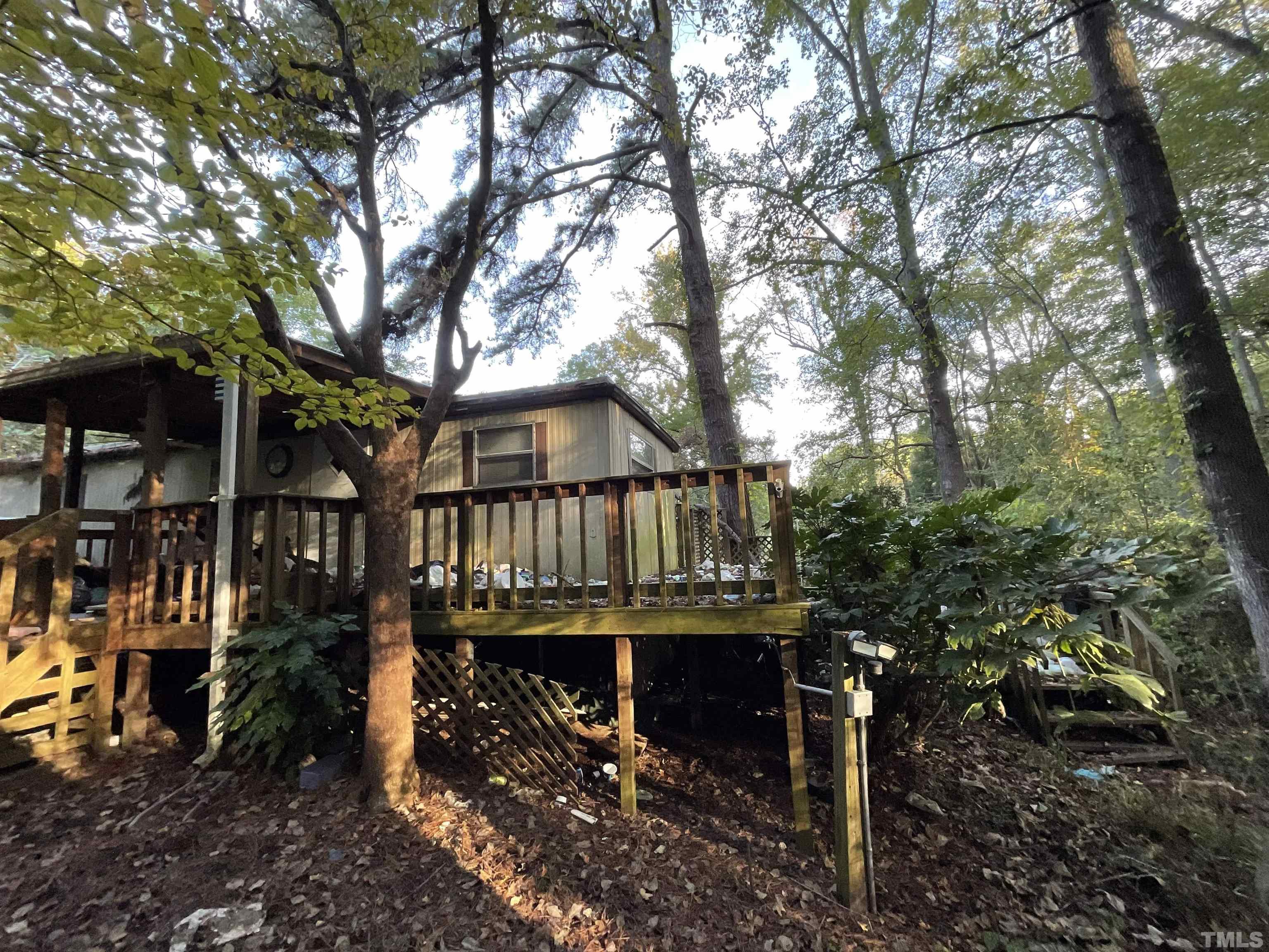 8229 Holly Springs Road Raleigh, NC 27606 - Photo 14 of 24 a view of a house with large trees and large trees