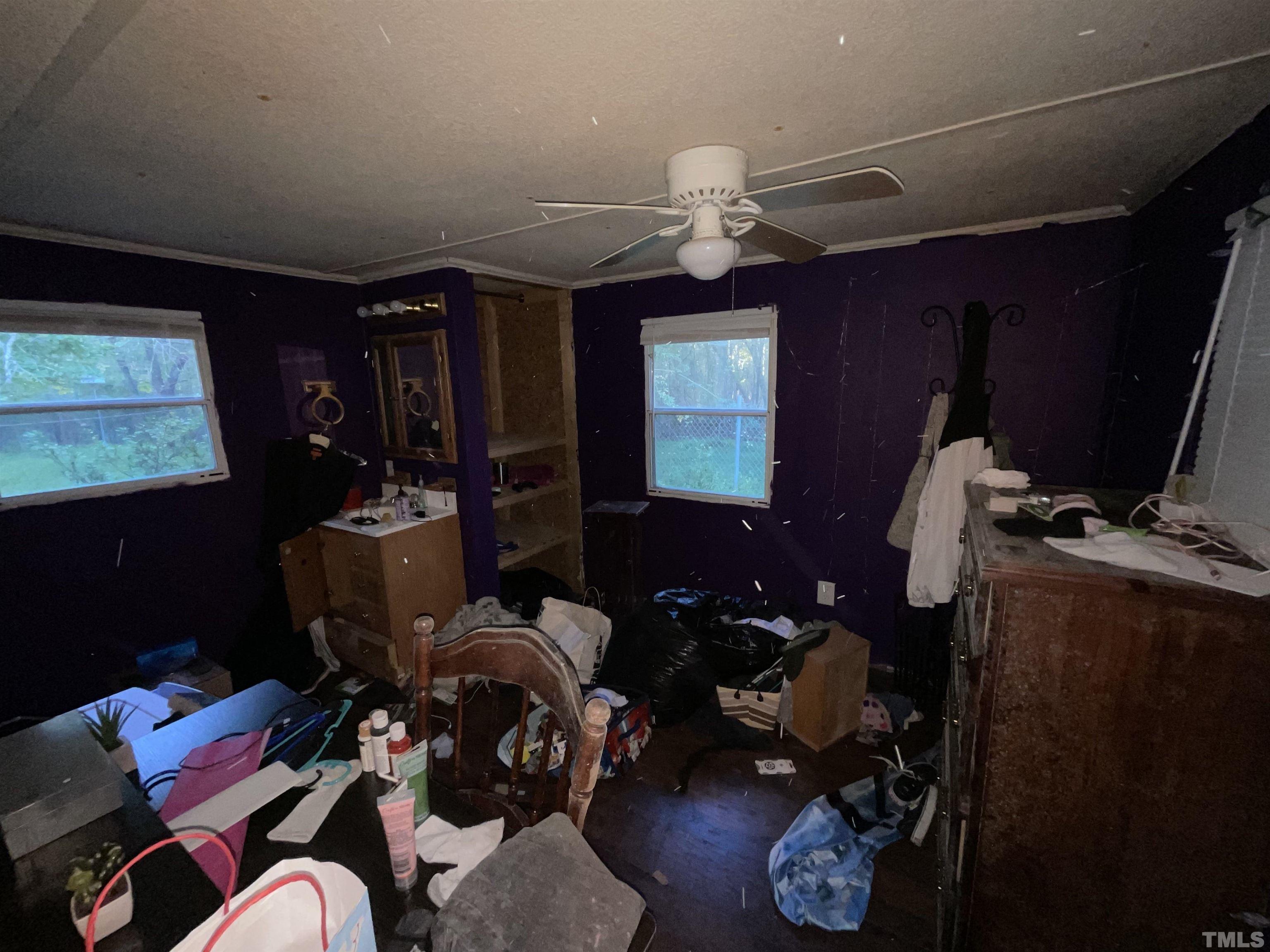 8229 Holly Springs Road Raleigh, NC 27606 - Photo 18 of 24 a living room with furniture a piano and a flat screen tv