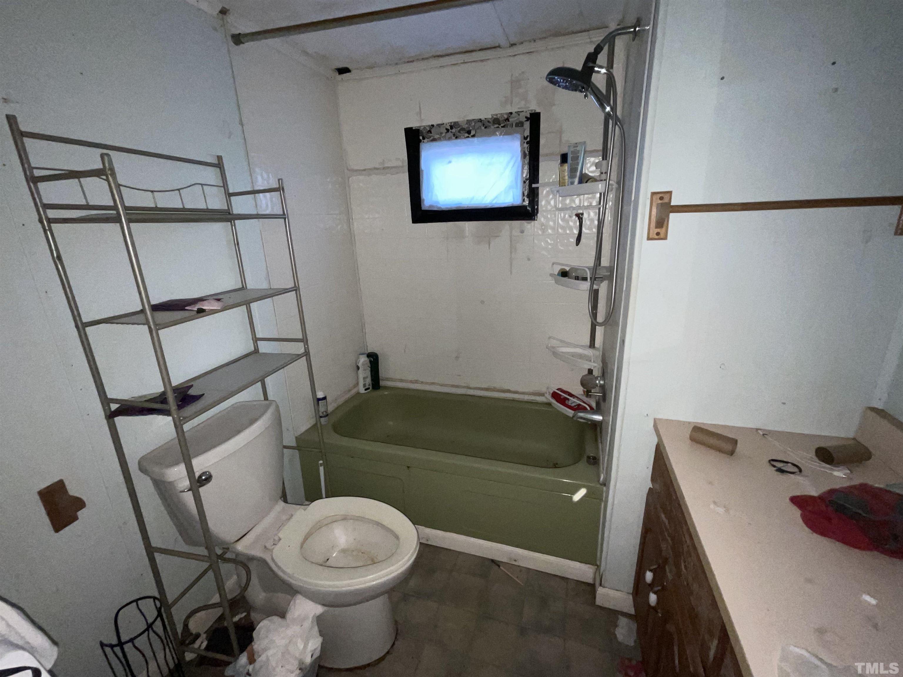 8229 Holly Springs Road Raleigh, NC 27606 - Photo 20 of 24 a bathroom with a sink toilet and shower