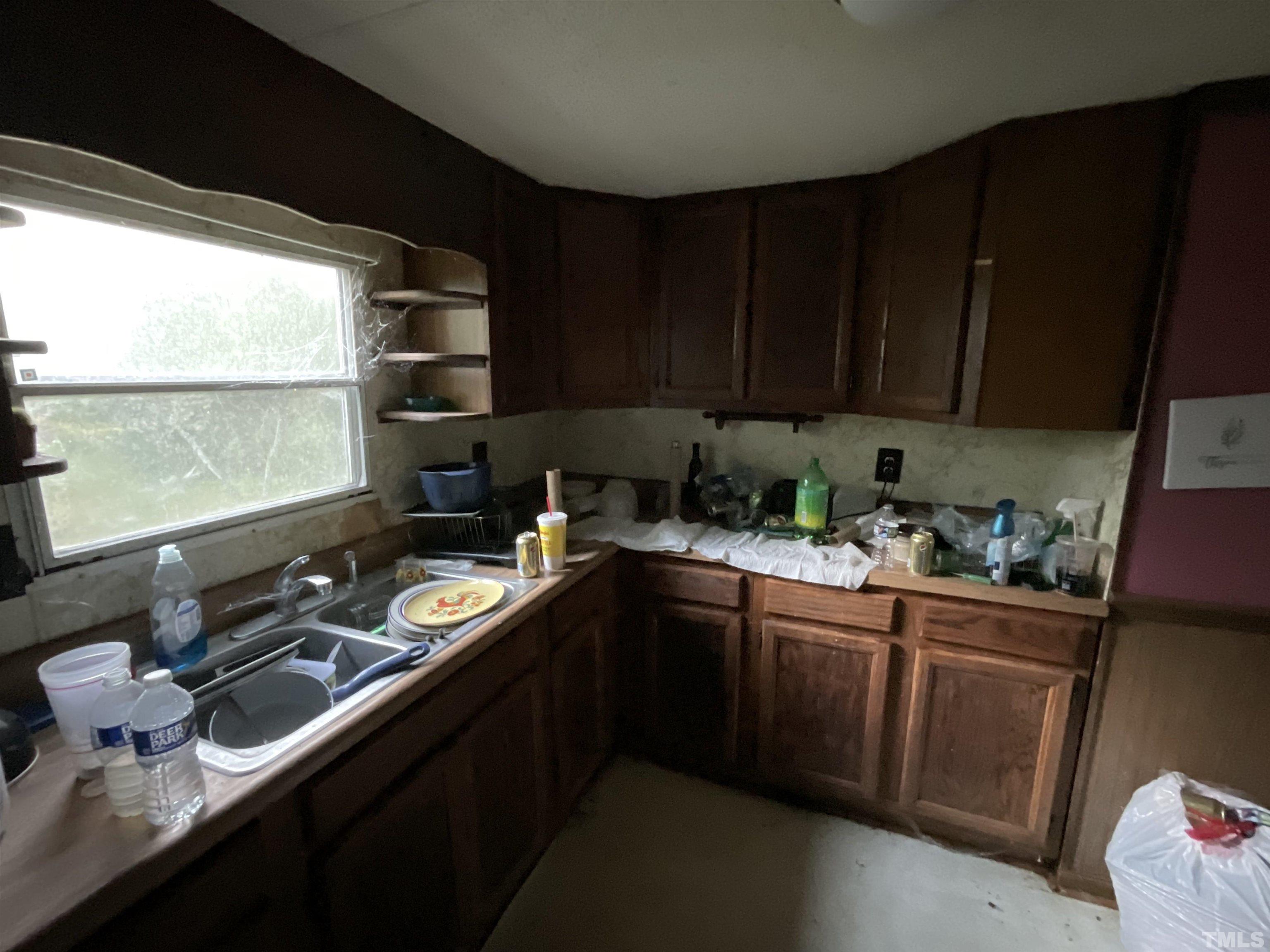 8229 Holly Springs Road Raleigh, NC 27606 - Photo 21 of 24 a kitchen with a sink stove and cabinets