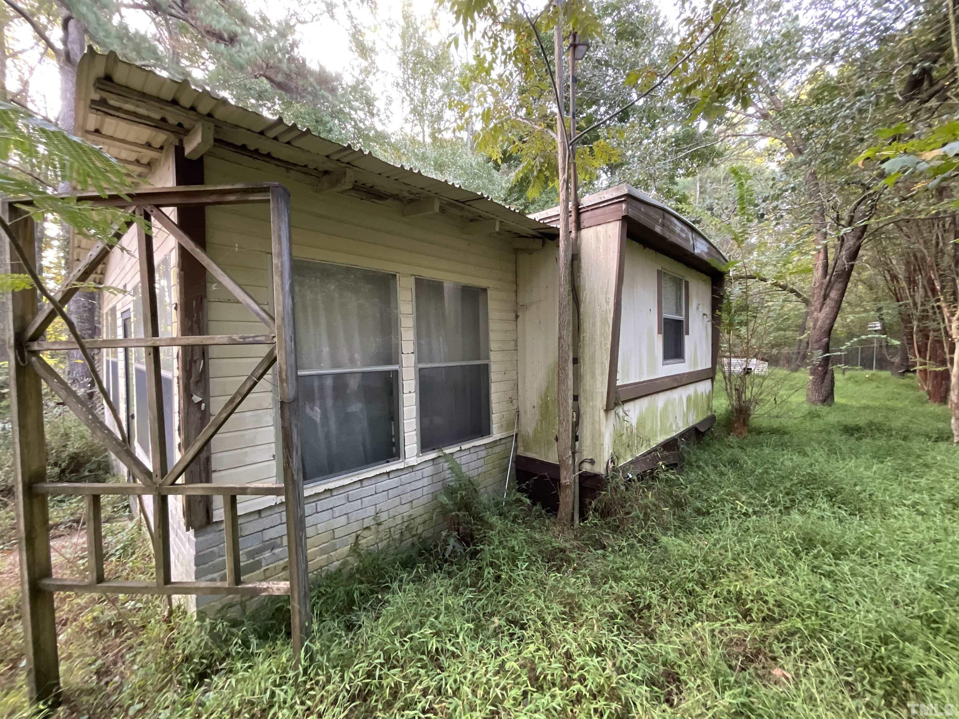 8229 Holly Springs Road Raleigh, NC 27606 - Photo 8 of 24 a backyard of a house with lots of green space